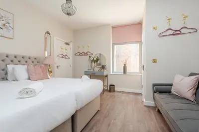 a bedroom with a large bed and a couch at RST Bramley Boutique in Liverpool