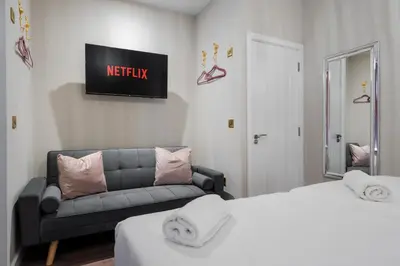 a room with two beds and a couch and a tv at RST Bramley Boutique in Liverpool