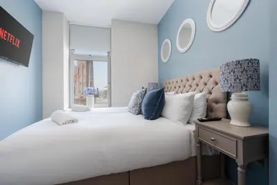 a bedroom with a large white bed and a window at RST Bramley Boutique in Liverpool