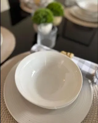 a white plate sitting on top of a table at Spacious Bungalow in St Helens, 1-Min Drive to Carr Mill Bridge in Saint Helens
