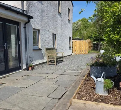 a patio with a bench in front of a house at Foundry View in Millom