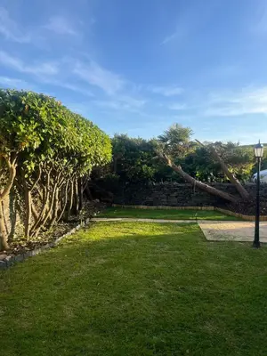 a park with green grass and trees and a street light at Seaview home in Baycliff, Cumbria in Baycliff