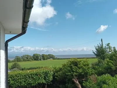 a view of a green field from a house at Seaview home in Baycliff, Cumbria in Baycliff