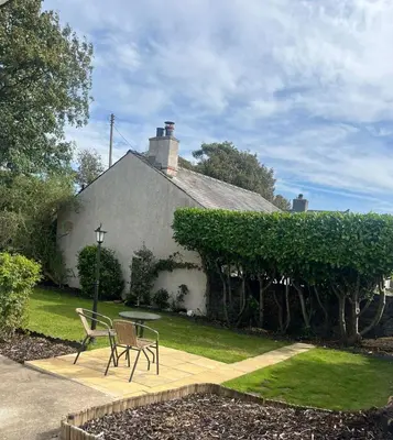 a house with a table and chairs in the yard at Seaview home in Baycliff, Cumbria in Baycliff