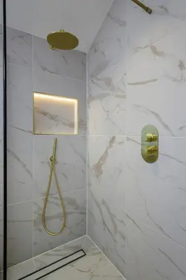 a bathroom with a shower with white marble walls at Stylish 4-Bed House Central Blackpool Family Stay in Blackpool
