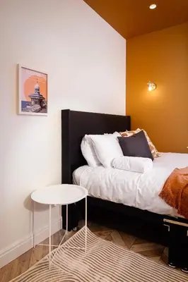 a bedroom with a bed and a small table at Stylish 4-Bed House Central Blackpool Family Stay in Blackpool