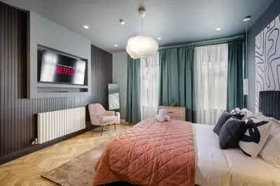 a bedroom with a bed with a tv on the wall at Stylish 4-Bed House Central Blackpool Family Stay in Blackpool