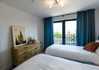 a bedroom with two beds and a window at Stylish Luxury Penthouse in Liverpool City Centre - Free Private Parking and Only 2km from Everton Stadium! in Liverpool