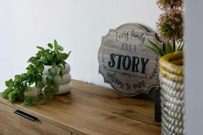 a wooden shelf with a plant and a sign on it at Stylish Luxury Penthouse in Liverpool City Centre - Free Private Parking and Only 2km from Everton Stadium! in Liverpool