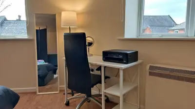 a room with a desk with a computer on it at Modern Studio Flat in Wigan in Wigan