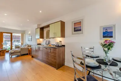 a kitchen and a living room with a table and a dining room at 2 Bed in Carnforth oc-s31763 in Warton