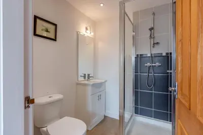 a bathroom with a shower and a toilet and a sink at 2 Bed in Carnforth oc-s31763 in Warton