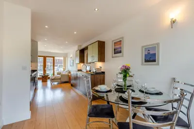a kitchen and living room with a table and chairs at 2 Bed in Carnforth oc-s31763 in Warton