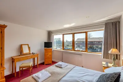 a bedroom with two beds and a desk and a window at 2 Bed in Carnforth oc-s31763 in Warton