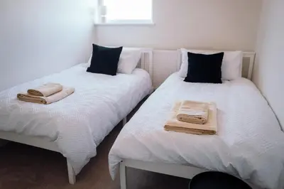 two beds with towels on them in a bedroom at Bradley's Hideaway With Private Garden in Eccleston