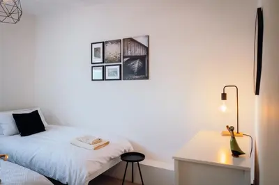a white bedroom with a bed and a desk at Bradley's Hideaway With Private Garden in Eccleston
