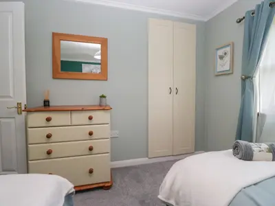 a bedroom with a dresser and a mirror at Sunset Retreat in Carnforth