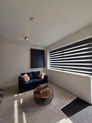 a living room with a couch and a table at Spacious New Studio in Blackburn Town Centre in Blackburn