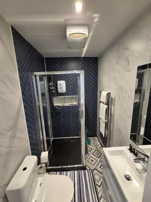 a bathroom with a shower and a toilet and a sink at Spacious New Studio in Blackburn Town Centre in Blackburn
