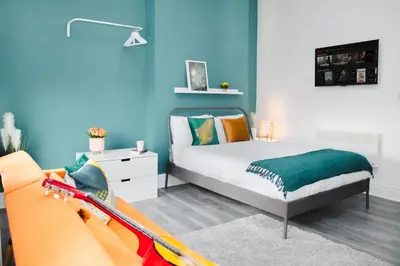 a small bedroom with a bed and a couch at Contractor Studio - Liverpool L5 - Sleeps 3 in Liverpool