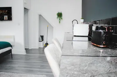 a living room with a marble table and chairs at Contractor Studio - Liverpool L5 - Sleeps 3 in Liverpool