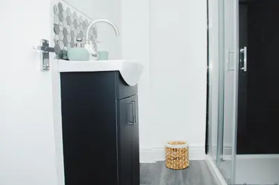 a bathroom with a sink and a shower at Contractor Studio - Liverpool L5 - Sleeps 3 in Liverpool