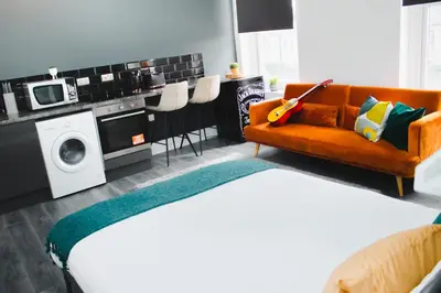 a living room with a bed and a couch at Contractor Studio - Liverpool L5 - Sleeps 3 in Liverpool