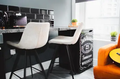 two white bar stools in a kitchen with a counter at Contractor Studio - Liverpool L5 - Sleeps 3 in Liverpool