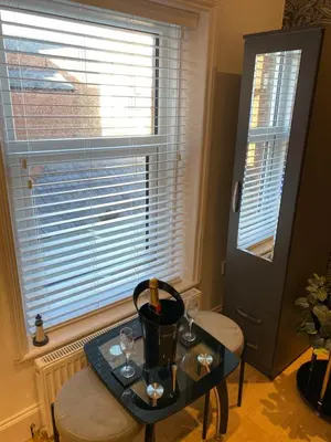 a room with a table with wine glasses and a window at The Fortress in Lytham St Annes