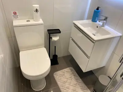 a bathroom with a white toilet and a sink at The Fortress in Lytham St Annes