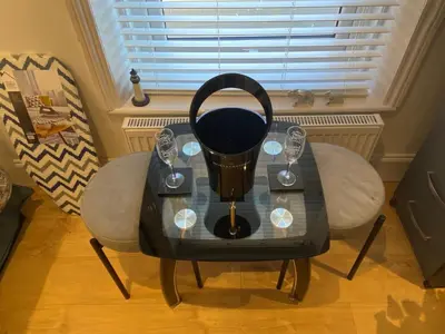 a table with two chairs and a blender on it at The Fortress in Lytham St Annes