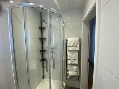 a shower with a glass door in a bathroom at The Fortress in Lytham St Annes