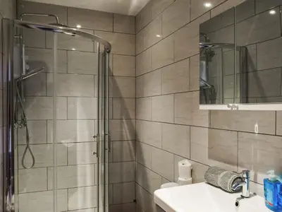 a bathroom with a shower and a sink at South Pier Apartment in Blackpool
