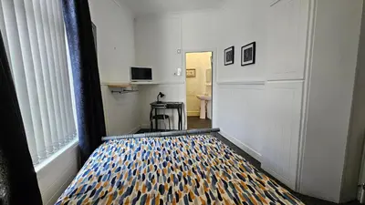 a hallway with a bed in a room at 6 Cocker Square in Blackpool