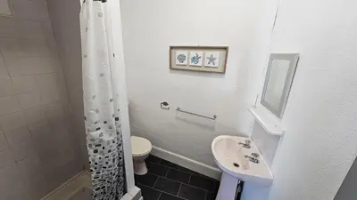 a bathroom with a sink and a toilet and a shower at 6 Cocker Square in Blackpool