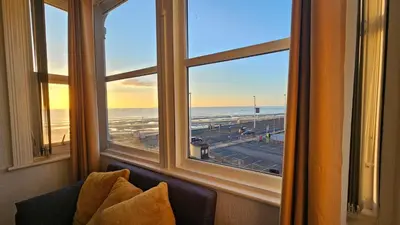 a room with a window with a view of the ocean at 6 Cocker Square in Blackpool