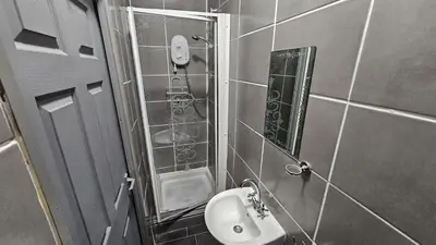 a small bathroom with a sink and a mirror at 6 Cocker Square in Blackpool