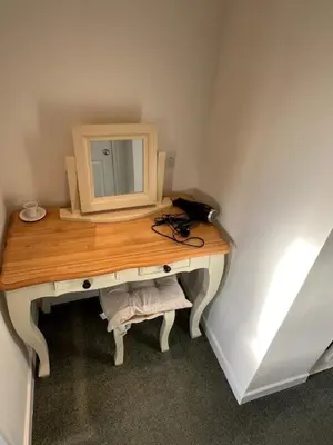 a dressing table with a mirror on top of it at Night Owl Cottage in Rainford