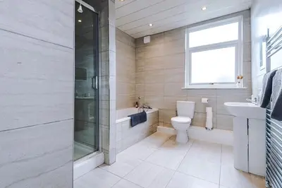 a bathroom with a toilet and a sink and a shower at #17 Walk to Anfield Stylish House for 12 in Liverpool