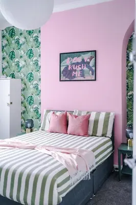 a bedroom with pink walls and a bed with pink pillows at #17 Walk to Anfield Stylish House for 12 in Liverpool