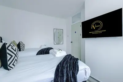a bedroom with a bed with a sign on the wall at New 2 Bed House - Perfect for Contractors & Families In St Helens Weekly & Monthly Stays in Saint Helens