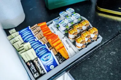 a display of food and drinks on a shelf at New 2 Bed House - Perfect for Contractors & Families In St Helens Weekly & Monthly Stays in Saint Helens
