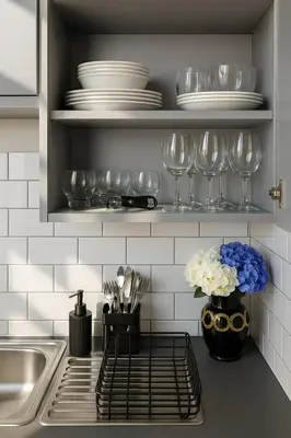 a kitchen counter with plates and glasses on a shelf at Central Apt, Parking, Walk to Shops, Bars & Trains in Liverpool