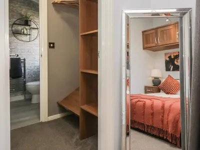 a bedroom with a bed and a mirror at Gressingham View Lodge in Carnforth