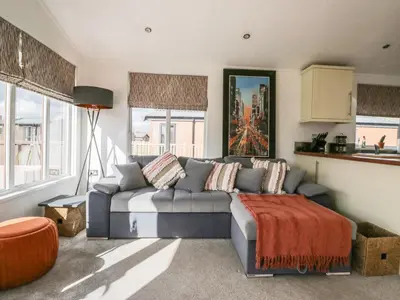a living room with a couch and a table at Gressingham View Lodge in Carnforth