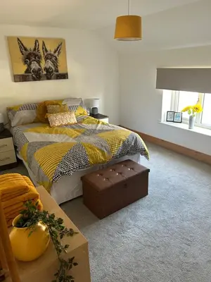 a bedroom with a bed and a table in it at Oswaldtwistle Farmhouse in Oswaldtwistle