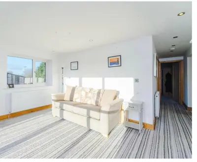 a living room with a white couch and a window at Oswaldtwistle Farmhouse in Oswaldtwistle