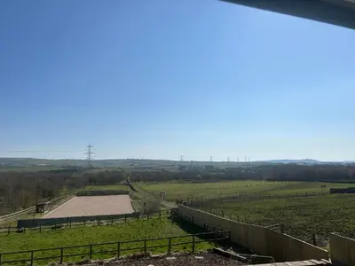 a view of a farm with a fence and a field at Oswaldtwistle Farmhouse in Oswaldtwistle