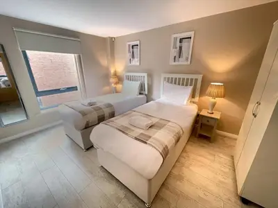 a bedroom with two beds and a window at 2BR City Centre Apt - Balcony - Sleeps 6 in Liverpool