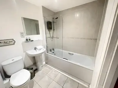 a bathroom with a toilet and a shower and a sink at 2BR City Centre Apt - Balcony - Sleeps 6 in Liverpool